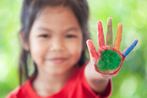 Asian girl doing a painting activity