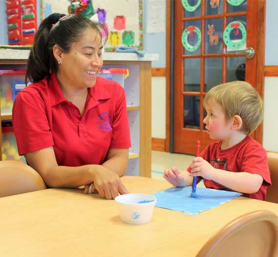teacher and kid in red shirt